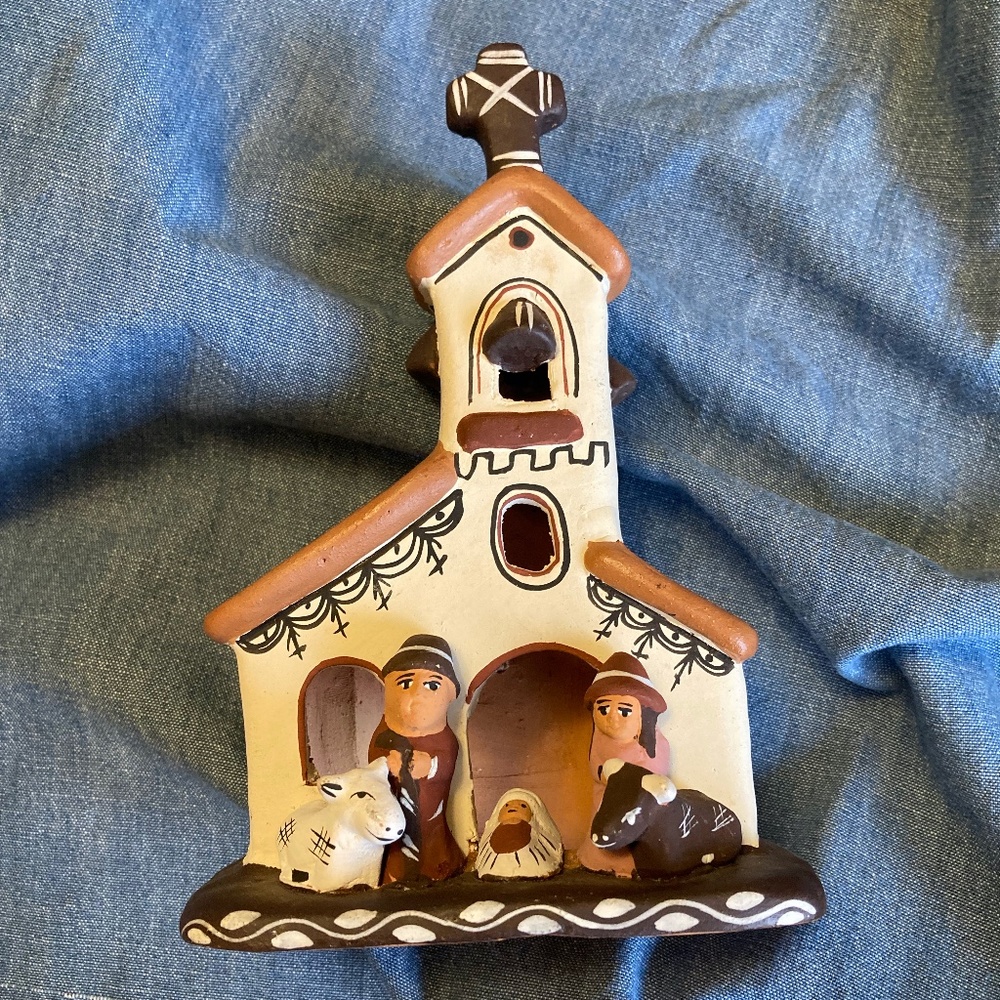 Peruvian red clay ceramic church scene with two adults and baby.